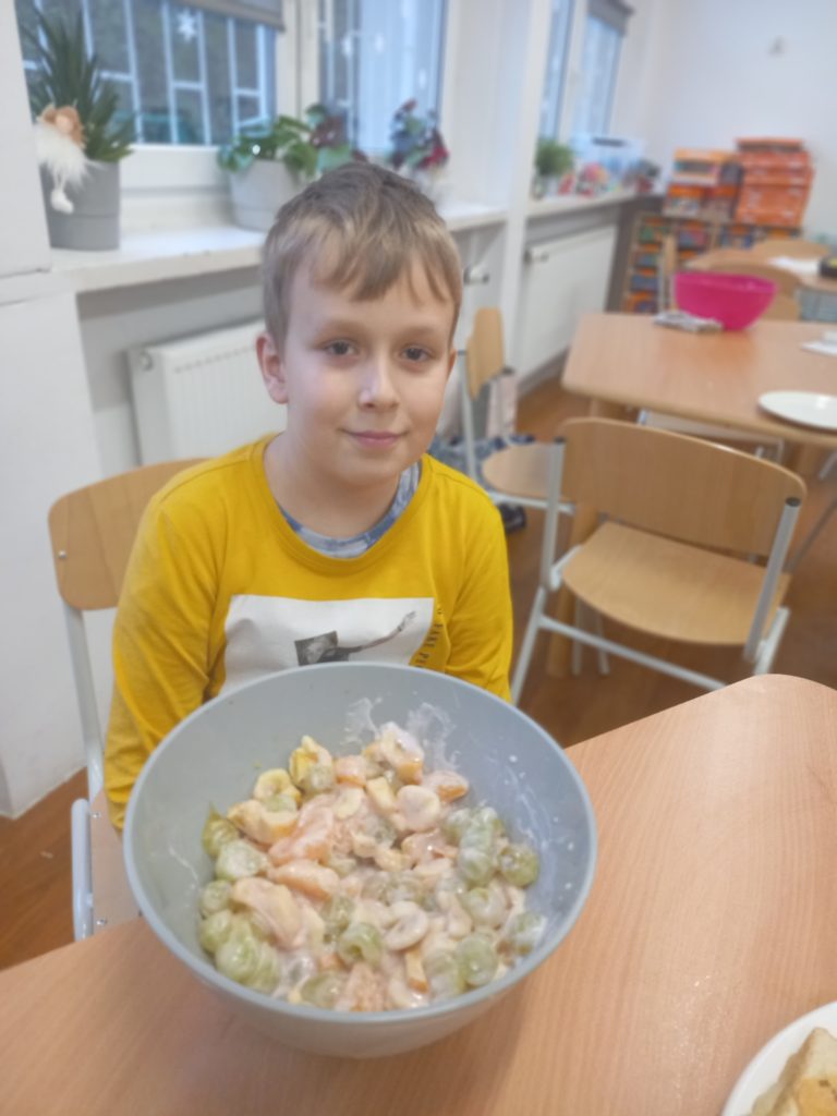 uczeń prezentuje sałatkę w misce