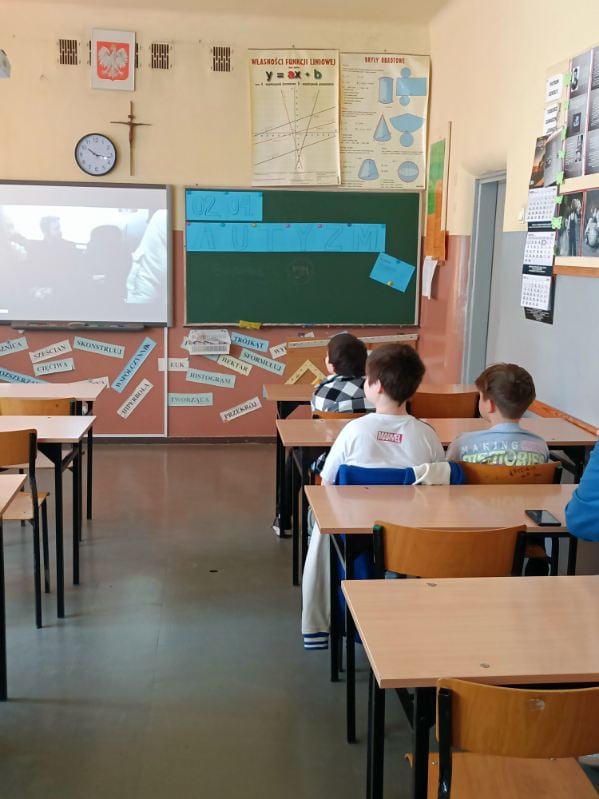 zdjęcie przedstawia jak uczniowie siedzą w ławkach