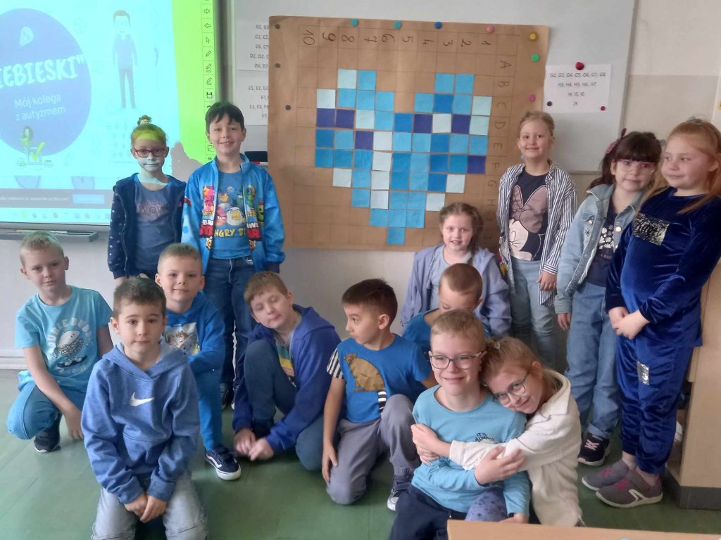 zdjęcie przedstawia zdjecie grupowe klasy 1a na tle niebieskiego serca