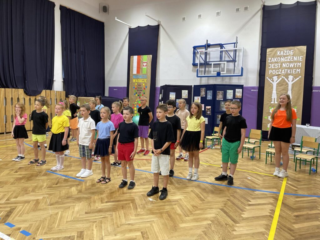 grupa dzieci ubrana na kolorowo śpiewai. 