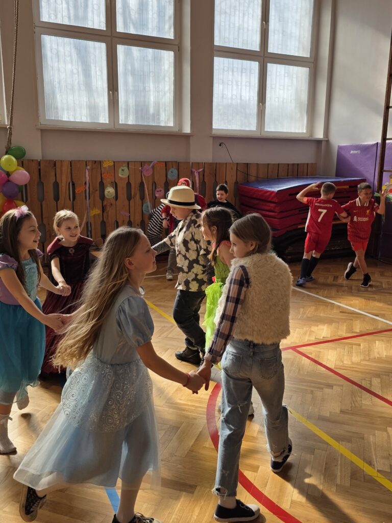 dzieci tańczą przebrane w różne stroje na balu