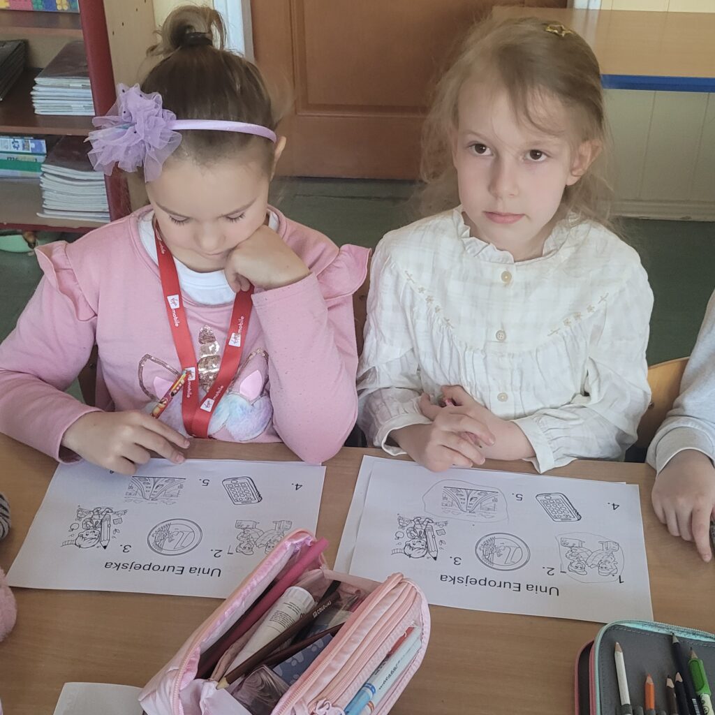 dwie uczennice siedzą przy karcie pracy