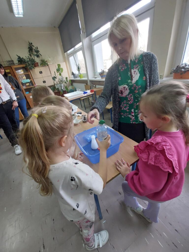pani prezentuje eksperyment chemiczny