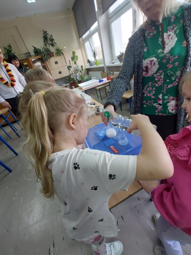 pani prezentuje eksperyment chemiczny