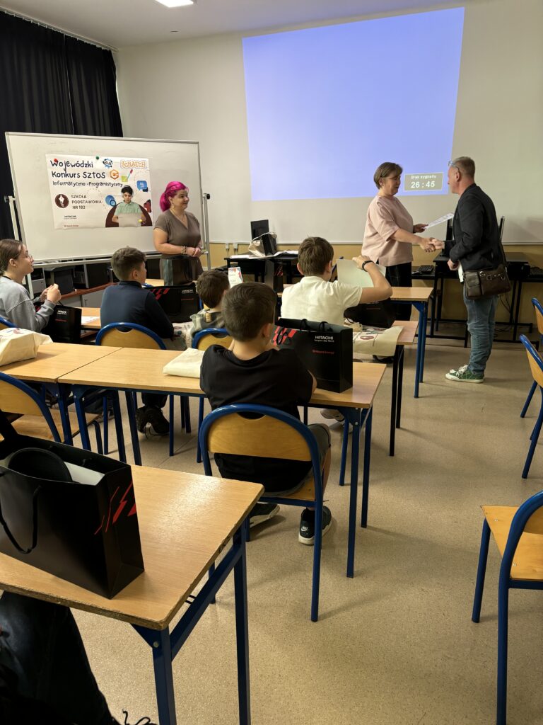 Pani Dyrektor wręcza dyplom i nagrodę opiekunowi ucznia w konkursie