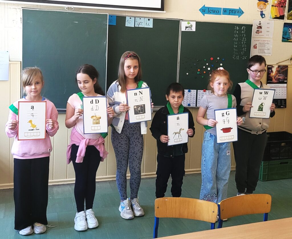 uczniowie trzymają literki w kolejności alfabetycznej
