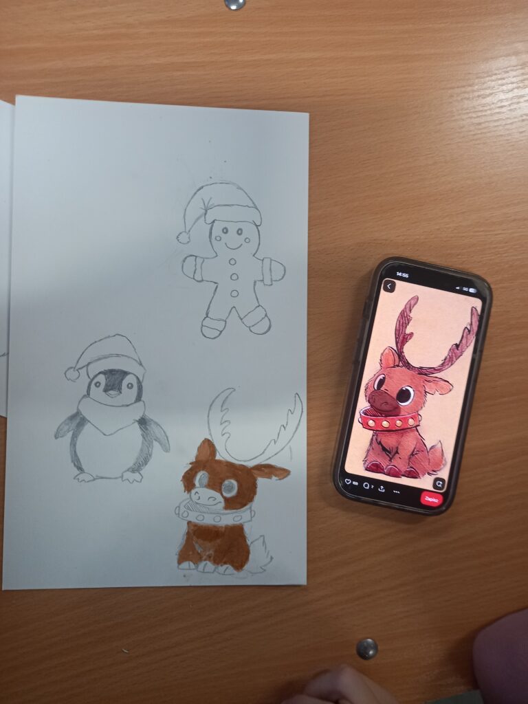 uczeń przemalowuje renifera na kartkę ze zdjęcia z telefonu