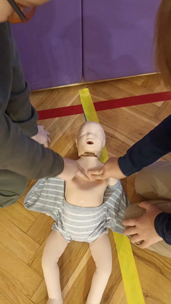 uczniowie ćwiczą na fantomie pierwszą pomoc.