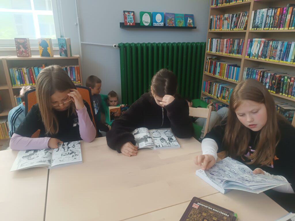 dziewczynki czyta książkę w ławce
